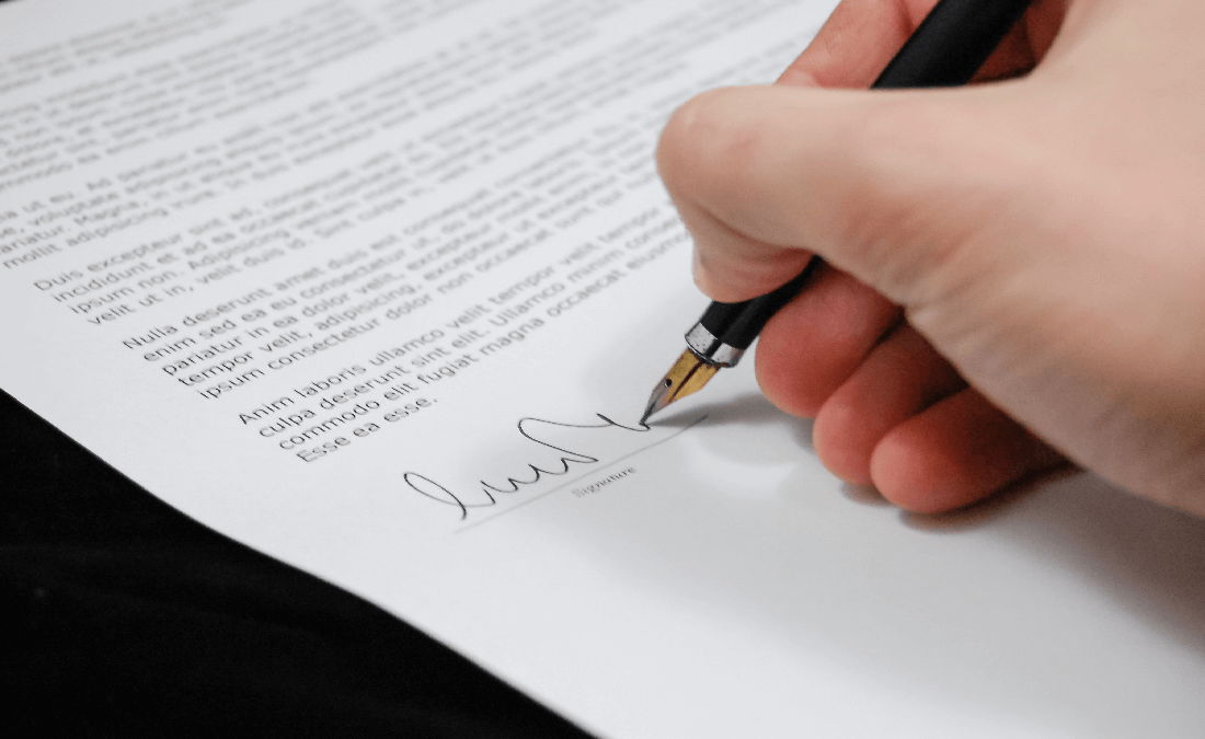 Lawyer signing contract for client