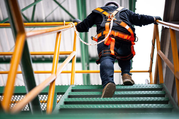construction man climbing a staircase with gear on in middletown, ct