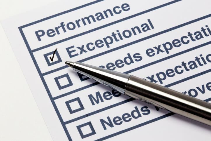 Performance evaluation paper with pen and tick marks
