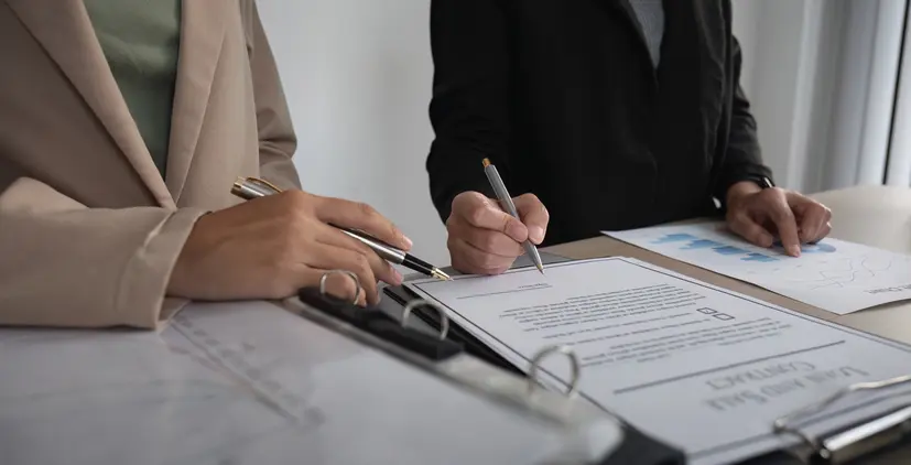 Close-up of the agreement document being signed. Business contract of young businesswoman.