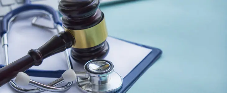 Gavel and stethoscope. medical jurisprudence. legal definition of medical malpractice. attorney. common errors doctors, nurses and hospitals make